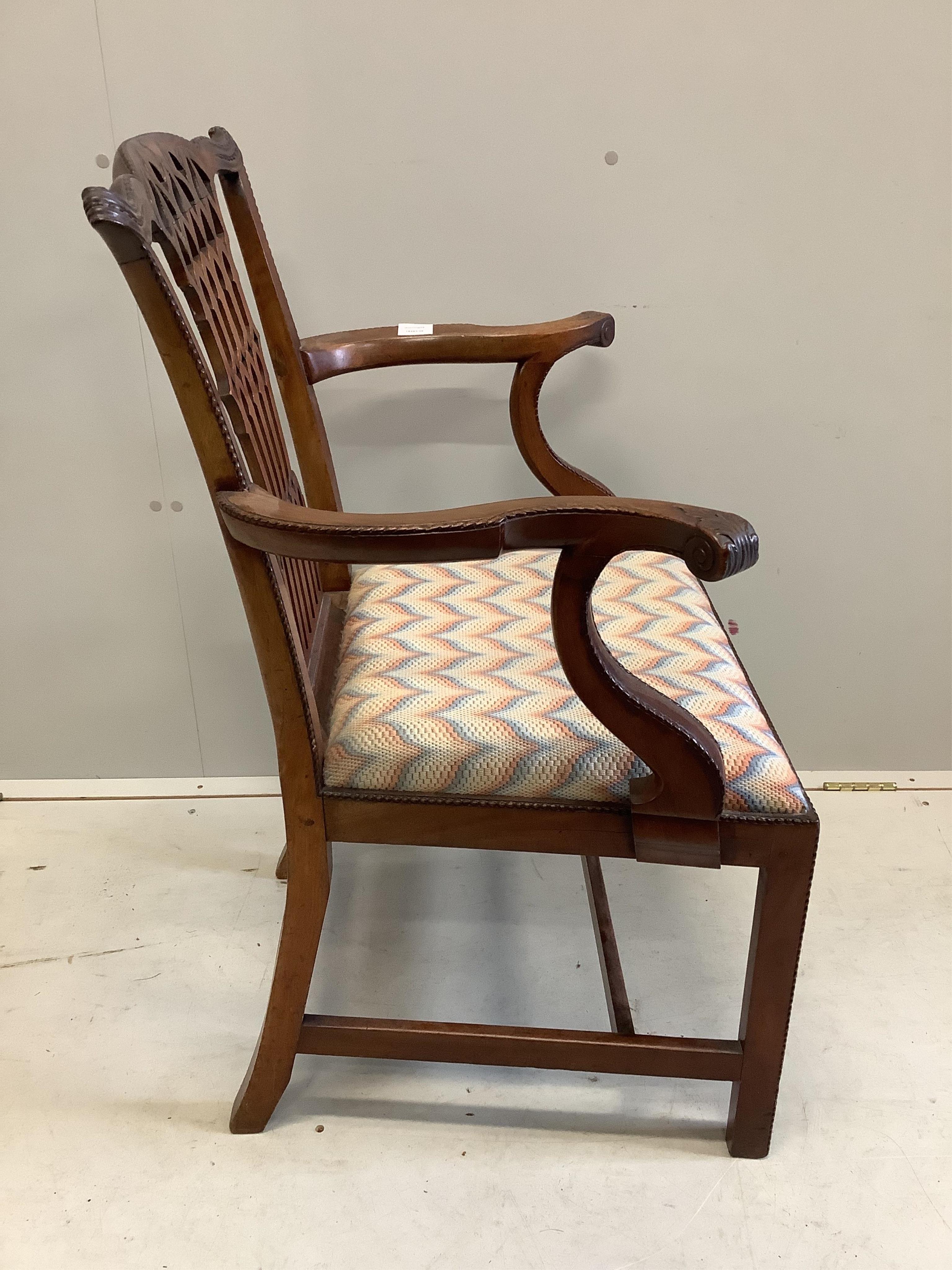 A George III mahogany elbow chair, with shaped arms and a pierced splat, width 70cm, depth 47cm, height 94cm. Condition - fair